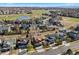 Lovely aerial view featuring a neighborhood with manicured lawns next to a golf course with a pond at 1788 Alpine Dr, Erie, CO 80516