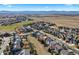 An aerial view of a golf course and residential neighborhood with mountain views at 1788 Alpine Dr, Erie, CO 80516