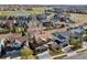 Panoramic aerial view of a residential neighborhood showcasing manicured lawns, mature trees, and nearby golf course at 1788 Alpine Dr, Erie, CO 80516