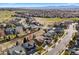 Breathtaking aerial view of a neighborhood next to a golf course, with houses and manicured lawns at 1788 Alpine Dr, Erie, CO 80516