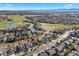 Beautiful aerial view showcasing a suburban neighborhood, golf course, and mountain landscape at 1788 Alpine Dr, Erie, CO 80516