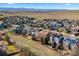 Panoramic aerial view showcases a community with solar panels, mountain views, and green spaces at 1788 Alpine Dr, Erie, CO 80516