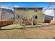 View of the backyard with green grass and a wooden deck attached to the house at 1788 Alpine Dr, Erie, CO 80516