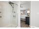Walk-in shower with glass door complemented by a view to the bedroom at 1788 Alpine Dr, Erie, CO 80516