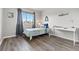 Bright bedroom with a daybed, white desk, and large window at 1788 Alpine Dr, Erie, CO 80516