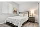 Cozy bedroom features a comfortable bed, wood floors, a nightstand, and ample natural light for relaxation at 1788 Alpine Dr, Erie, CO 80516