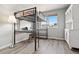 Bedroom with lofted bed and attached desk complemented by a white cabinet at 1788 Alpine Dr, Erie, CO 80516
