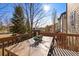 Outdoor deck features a wood table, chairs, and railing, perfect for enjoying the scenery on sunny days at 1788 Alpine Dr, Erie, CO 80516