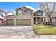 Charming two-story home boasts a stone facade, three-car garage, and inviting front yard at 1788 Alpine Dr, Erie, CO 80516