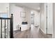 Hallway features wood floors, a welcome bench, and access to bedrooms at 1788 Alpine Dr, Erie, CO 80516