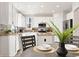 Bright kitchen featuring stainless steel appliances, white cabinets, granite counters, and a center island at 1788 Alpine Dr, Erie, CO 80516