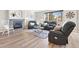 Comfortable living room with fireplace, leather seating, and large windows at 1788 Alpine Dr, Erie, CO 80516
