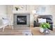 Comfortable living room with fireplace, tile surround, plush leather chair, and soft lighting at 1788 Alpine Dr, Erie, CO 80516