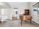 Bright living room with hardwood floors, neutral paint, large windows, and a vintage piano at 1788 Alpine Dr, Erie, CO 80516