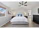 Spacious main bedroom features a ceiling fan, a king bed, a large window and ensuite bathroom access at 1788 Alpine Dr, Erie, CO 80516