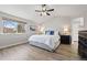 Bright main bedroom with wood floors and a large window, offering a comfortable and relaxing atmosphere at 1788 Alpine Dr, Erie, CO 80516