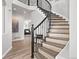 Elegant staircase features wrought iron railing, wood steps, and a 'welcome' decor at 1788 Alpine Dr, Erie, CO 80516