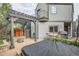 Backyard featuring a stone grill, custom pergola, fire pit, and modern patio at 1819 W 32Nd Ave, Denver, CO 80211