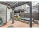 A backyard area with a wooden pergola, stone grill, and hot tub at 1819 W 32Nd Ave, Denver, CO 80211