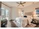 Bedroom features a ceiling fan, hardwood floors, and a sliding glass door that brings in plenty of natural light at 1819 W 32Nd Ave, Denver, CO 80211