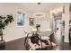 Dining room featuring a glass table, modern light fixture, hardwood floors, and decorated with plants at 1819 W 32Nd Ave, Denver, CO 80211