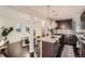 Open kitchen featuring granite countertops, stainless steel appliances, and a view to the dining area at 1819 W 32Nd Ave, Denver, CO 80211