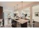 Open kitchen with granite island, stainless steel appliances, and view into a living room at 1819 W 32Nd Ave, Denver, CO 80211