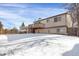 Elevated deck overlooks a spacious backyard covered in snow at 16651 E Arizona Pl, Aurora, CO 80017