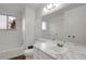 White bathroom featuring a marble countertop, a toilet, and a tub at 16651 E Arizona Pl, Aurora, CO 80017