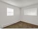 Well-lit bedroom with carpet flooring, white walls, windows, and an electric heater at 16651 E Arizona Pl, Aurora, CO 80017