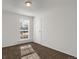 Carpeted bedroom featuring a window, a ceiling light, and a door at 16651 E Arizona Pl, Aurora, CO 80017