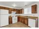 Galley style kitchen with wood cabinets and appliances at 16651 E Arizona Pl, Aurora, CO 80017