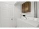 Functional laundry area with washer, dryer, and overhead storage at 16651 E Arizona Pl, Aurora, CO 80017