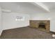 Spacious living room featuring a brick fireplace and carpet flooring at 16651 E Arizona Pl, Aurora, CO 80017