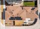 An aerial view of a rooftop with solar panels atop a brown shingled roof at 9976 E 63Rd Ave, Denver, CO 80238