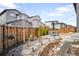 Private fenced backyard featuring a patio with a dining set and a garden path at 9976 E 63Rd Ave, Denver, CO 80238
