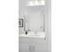 Bright bathroom with a modern single sink and picture frame at 9976 E 63Rd Ave, Denver, CO 80238