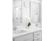 Bright bathroom featuring dual sinks, white countertops, and a modern aesthetic at 9976 E 63Rd Ave, Denver, CO 80238