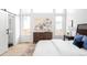 Serene bedroom with high ceilings, a modern dresser, and large windows at 9976 E 63Rd Ave, Denver, CO 80238