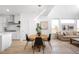 Well-lit dining area adjacent to the kitchen and living room at 9976 E 63Rd Ave, Denver, CO 80238