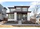 Contemporary two-story home featuring a modern design and inviting front porch at 9976 E 63Rd Ave, Denver, CO 80238