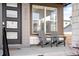 Inviting front porch area, complete with seating for relaxing outdoors at 9976 E 63Rd Ave, Denver, CO 80238