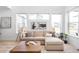 Comfortable living room with a large sofa and ample natural light at 9976 E 63Rd Ave, Denver, CO 80238