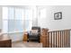 Relaxing loft featuring comfortable recliner, large windows, and neutral carpet at 9976 E 63Rd Ave, Denver, CO 80238