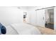 Stylish main bedroom with a barn door leading to a walk-in closet and en-suite bathroom at 9976 E 63Rd Ave, Denver, CO 80238