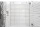 Minimalist shower stall with modern tile and recessed shelf at 9976 E 63Rd Ave, Denver, CO 80238