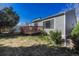 Exterior view of home with a well-maintained lawn and inviting wooden deck at 5160 Hannibal St, Denver, CO 80239