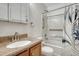 Well-lit bathroom with a shower-tub combo, granite vanity, and functional storage at 5160 Hannibal St, Denver, CO 80239