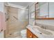 Bathroom features a walk-in shower with glass door and single sink vanity at 5160 Hannibal St, Denver, CO 80239