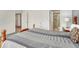 Cozy bedroom features a wood bed, side table and ensuite bath through the doorway at 5160 Hannibal St, Denver, CO 80239